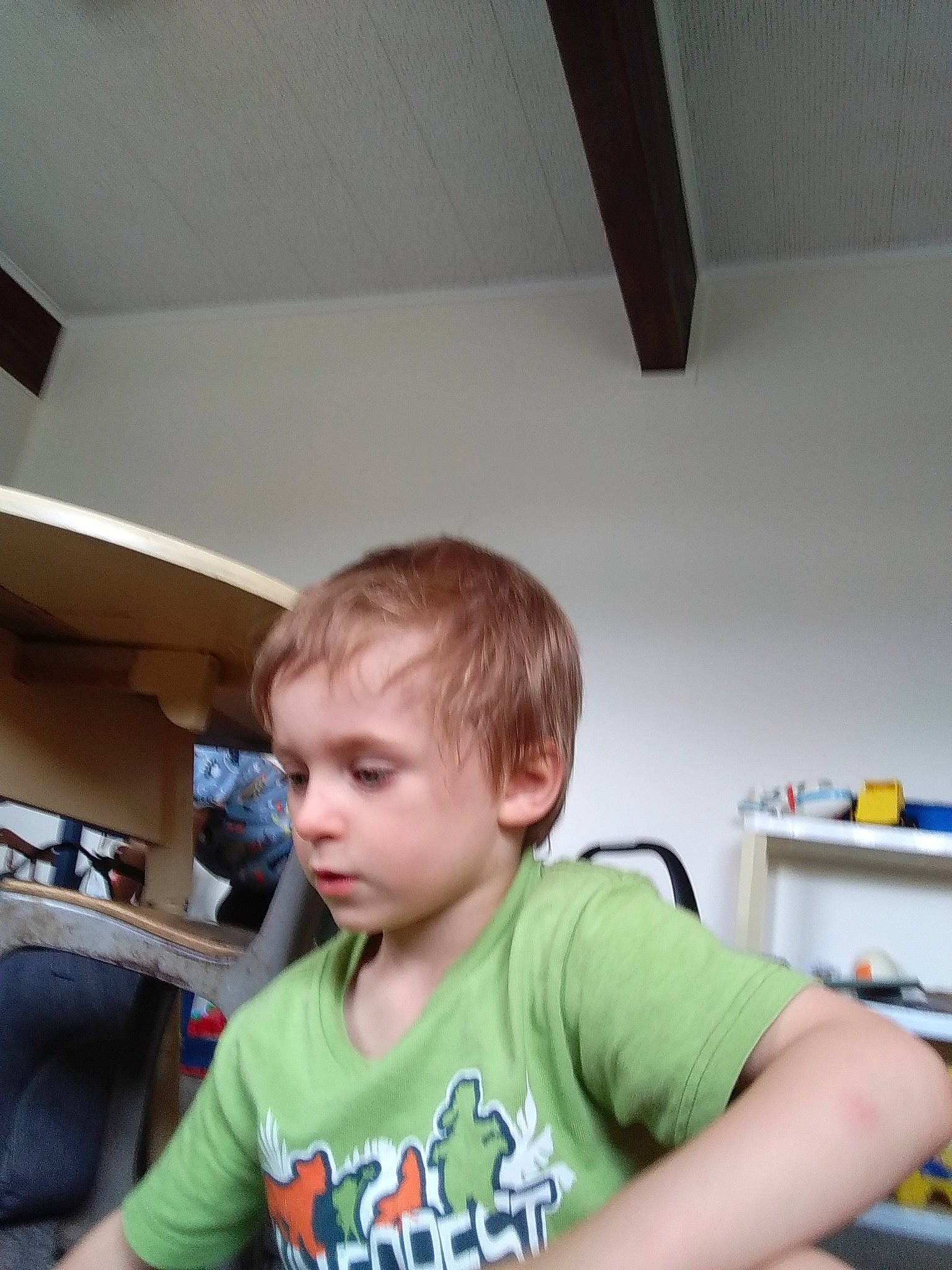 Derrek is registered to the contest to win money with this photo: ceiling, chair, child, flooring, fun, happy, person, play, room, shelf, sitting, sleeve, t_shirt, toddler, wood