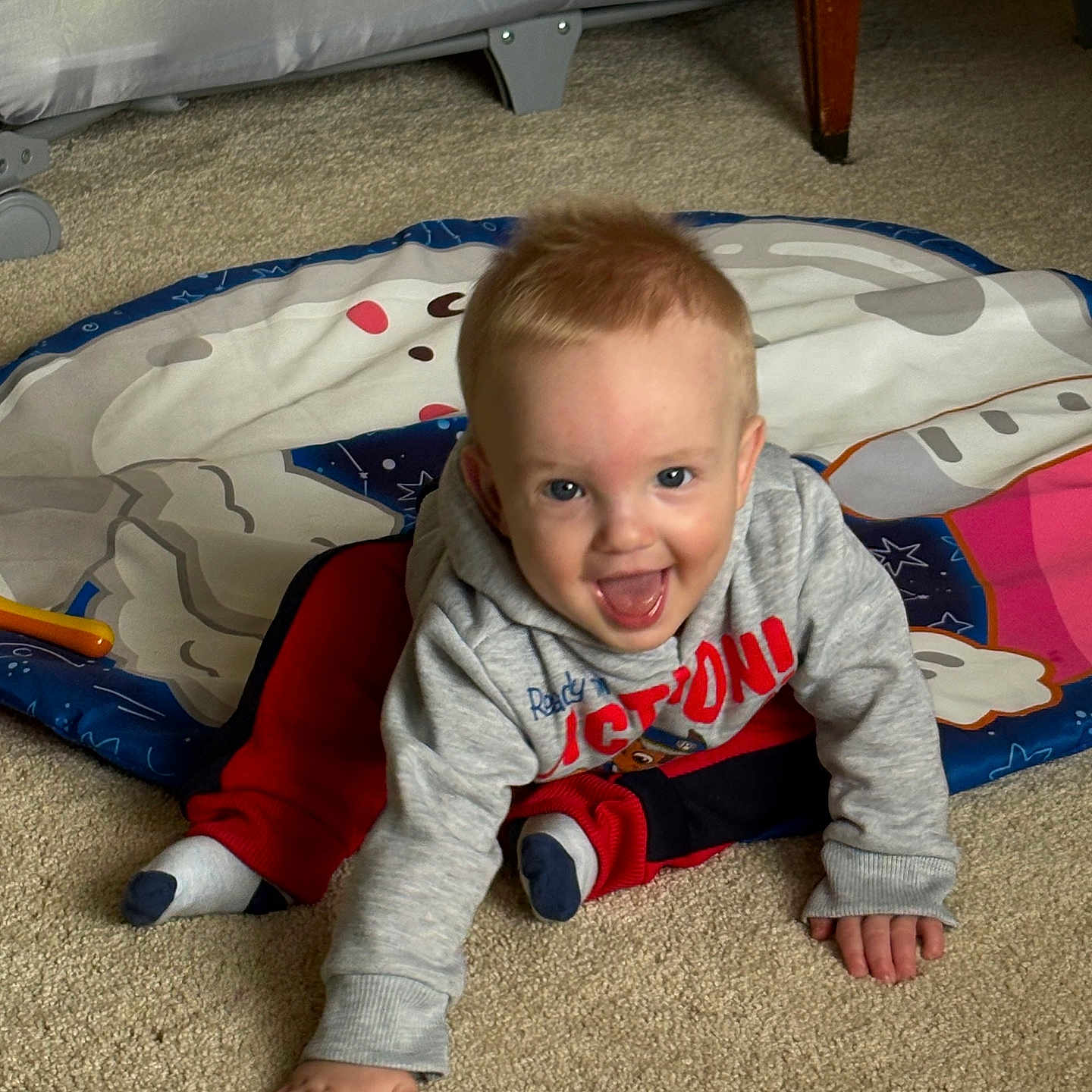 Michael joined the competition — help win amazing prizes! baby, child, crawling, carpet, playmat, hoodie, red_pants, smiling, indoor, crib, furniture, happy, person, floor, cute, toddler, clothing, toy, home, young