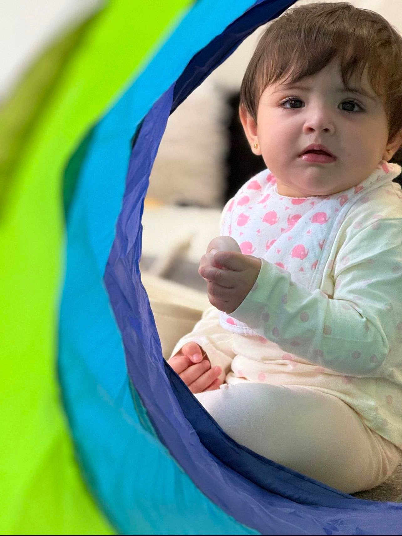 Mahwa joined the competition — help win amazing prizes! baby, child, indoor, play_tunnel, colorful, curious, soft_lighting, cozy, clothing, sitting, toy, face, person, cute, infant, expression, hand, head, pink, white