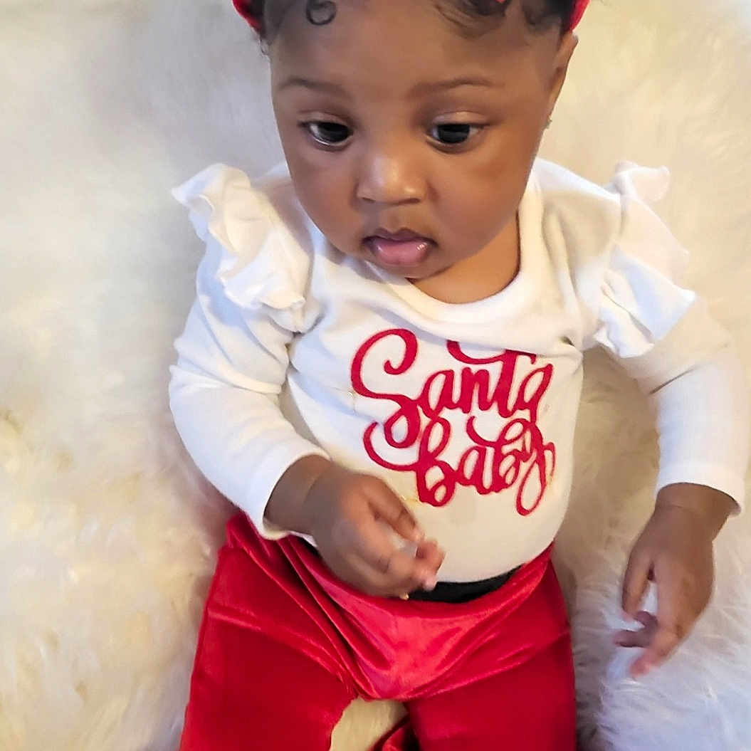 Divineness joined the competition — help win amazing prizes! adorable, baby, child, curly_hair, cute, fashion, festive, fluffy_background, headband, holiday_outfit, indoors, infant, portrait, red_bow, red_pants, sitting, soft_texture, velvet, white_shirt, young_child