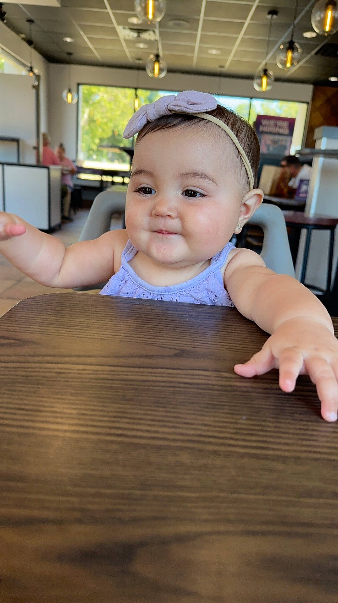 Aria is registered to the contest to win money with this photo: baby, baby_toddler_clothing, cheek, child, ear, eyelash, finger, flooring, fun, happy, hardwood, leisure, person, sitting, skin, smile, table, thumb, toddler, varnish
