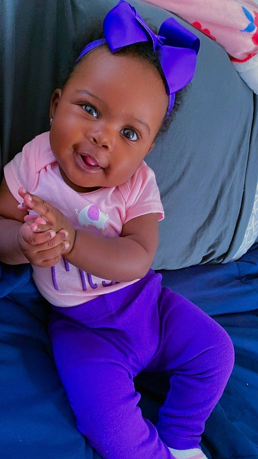 Laila is registered to the contest to win money with this photo: abdomen, active_pants, baby, baby_toddler_clothing, blue, child, curtain, electric_blue, event, fun, gesture, happy, iris, leisure, magenta, person, pink, purple, smile, thumb