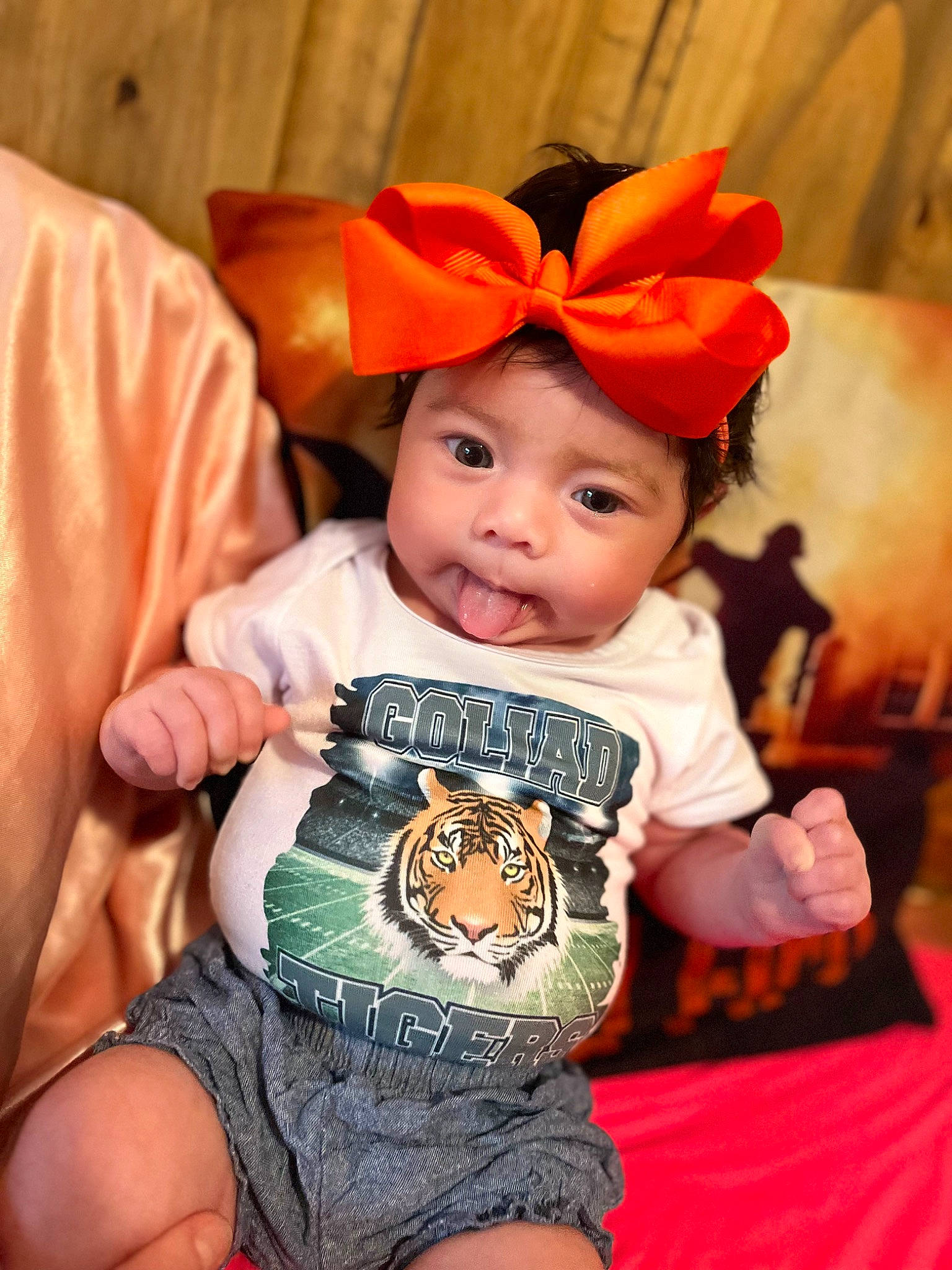 Averi is registered to the contest to win money with this photo: baby, baby_toddler_clothing, beauty, cheek, child, costume_hat, event, facial_expression, fun, happy, hat, headwear, orange, pattern, person, pink, sitting, skin, sleeve, t_shirt