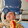 Avyaan is registered to the contest to win money with this photo: baby, child, toy, colorful, smiling, face, indoor, floor, mat, curious, playtime, happy, infant, couch, living_room, earrings, clothing, closeup, cheerful, home