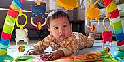 Avyaan joined the competition — help win amazing prizes! baby, play_mat, colorful_toys, baby_gym, living_room, curtains, sofa, carpet, child, infant, floor_play, indoor, cute, colorful, toy_arch, onesie, toddler, furniture, bright, happy