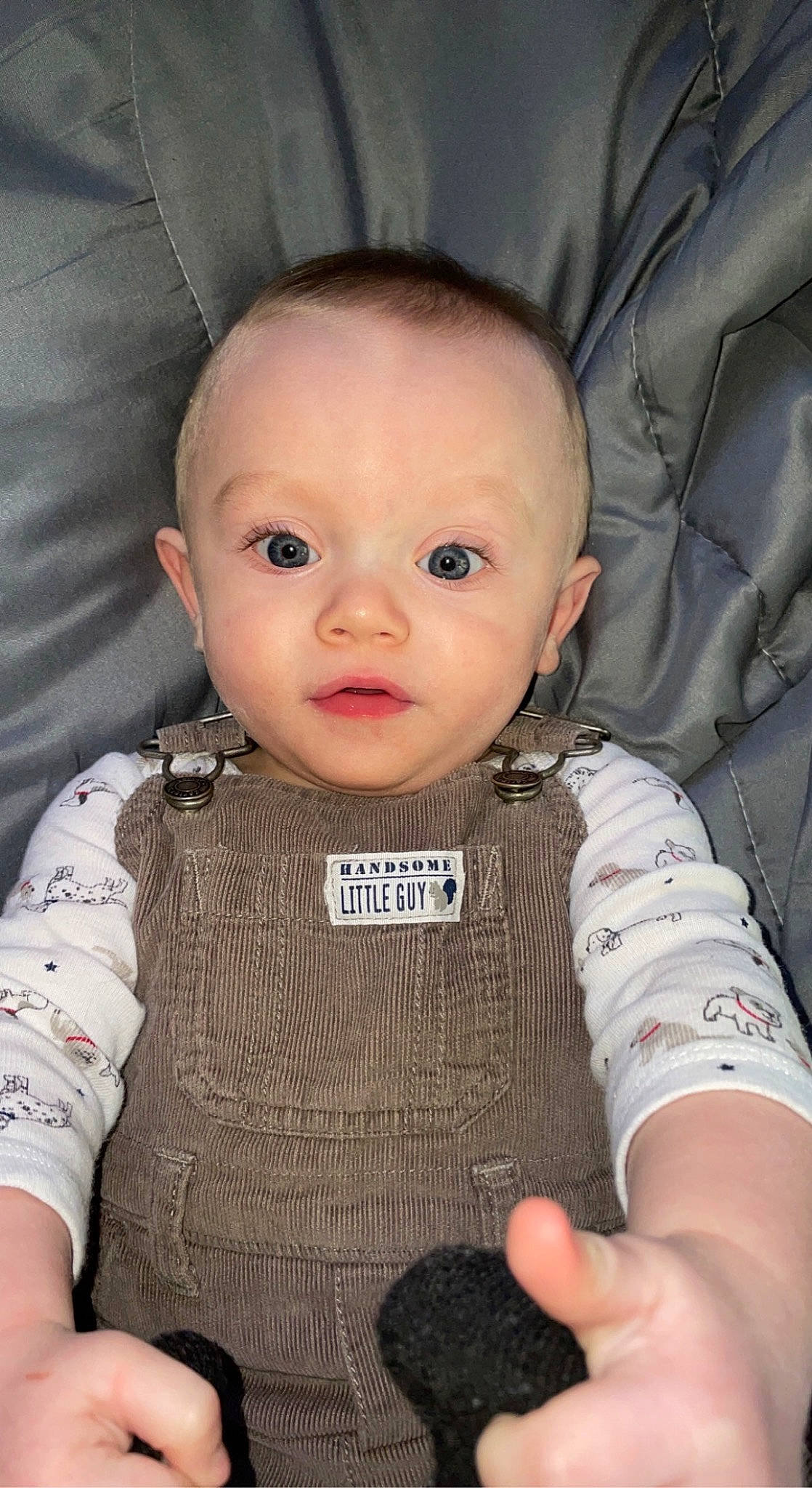Ryder is registered to the contest to win money with this photo: baby, baby_products, baby_toddler_clothing, cheek, child, collar, comfort, cool, eyelash, finger, iris, lip, mouth, nose, person, sitting, skin, sleeve, smile, thumb