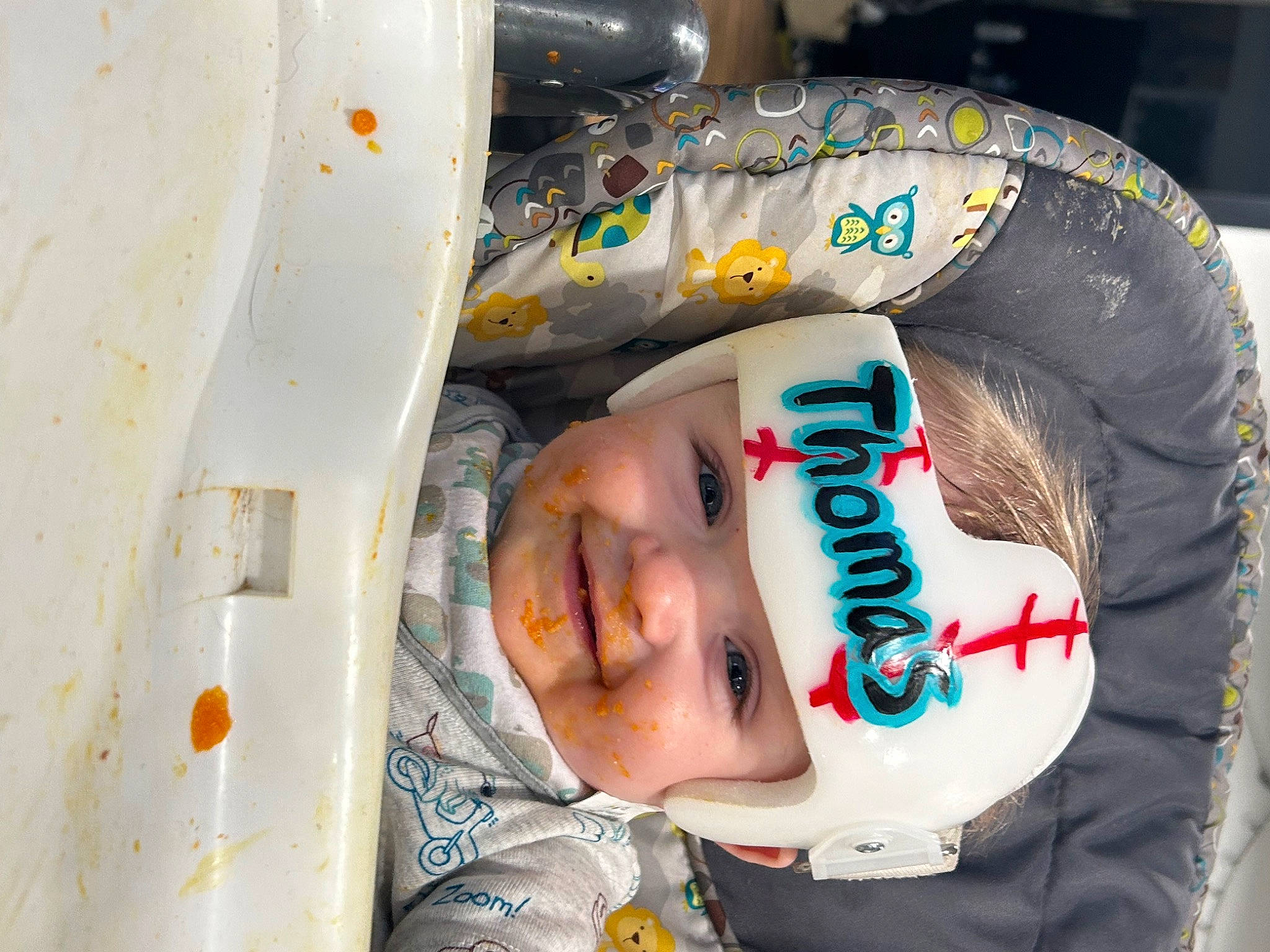 Thomas is registered to the contest to win money with this photo: baby, baby_toddler_clothing, child, circle, fun, happy, hat, headgear, headwear, helmet, joy, person, personal_protective_equipment, plastic, sleeve, smile, space, toddler