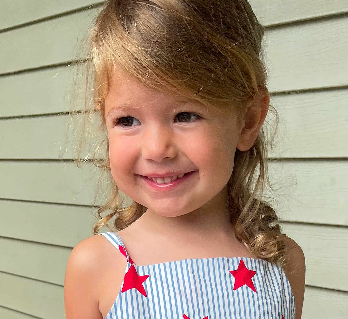 Freya joined the competition — help win amazing prizes! child, smiling, blonde_hair, curly_hair, dress, stars, striped, portrait, happy, face, shoulder, outdoor, person, young, cute, skin, head, eyebrows, eyes, background