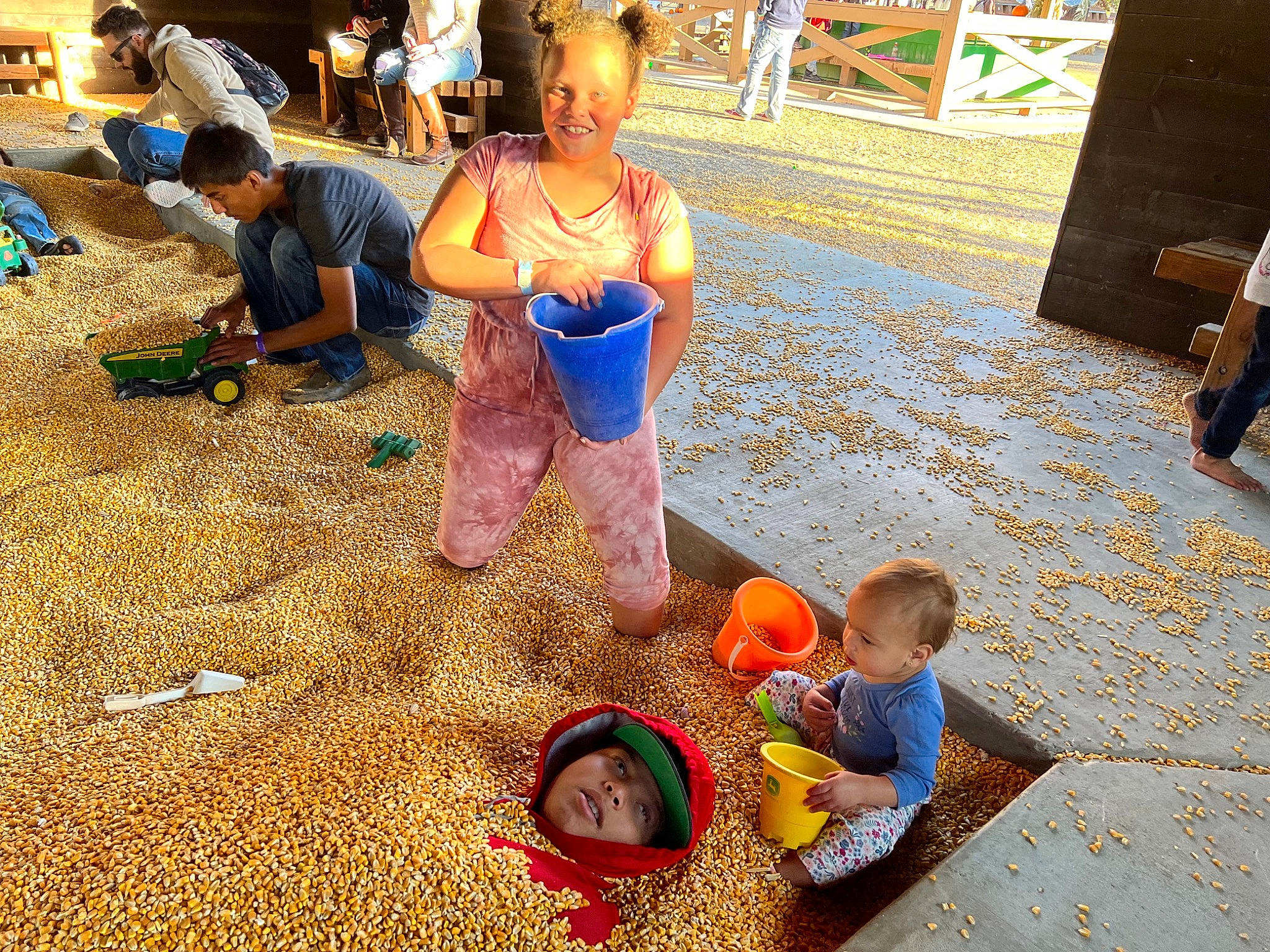 Jazmine is registered to the contest to win money with this photo: baby, baby_toddler_clothing, child, city, event, flooring, fun, happy, hat, headwear, human_settlement, joy, leisure, orange, people, person, photograph, recreation, shorts, sitting