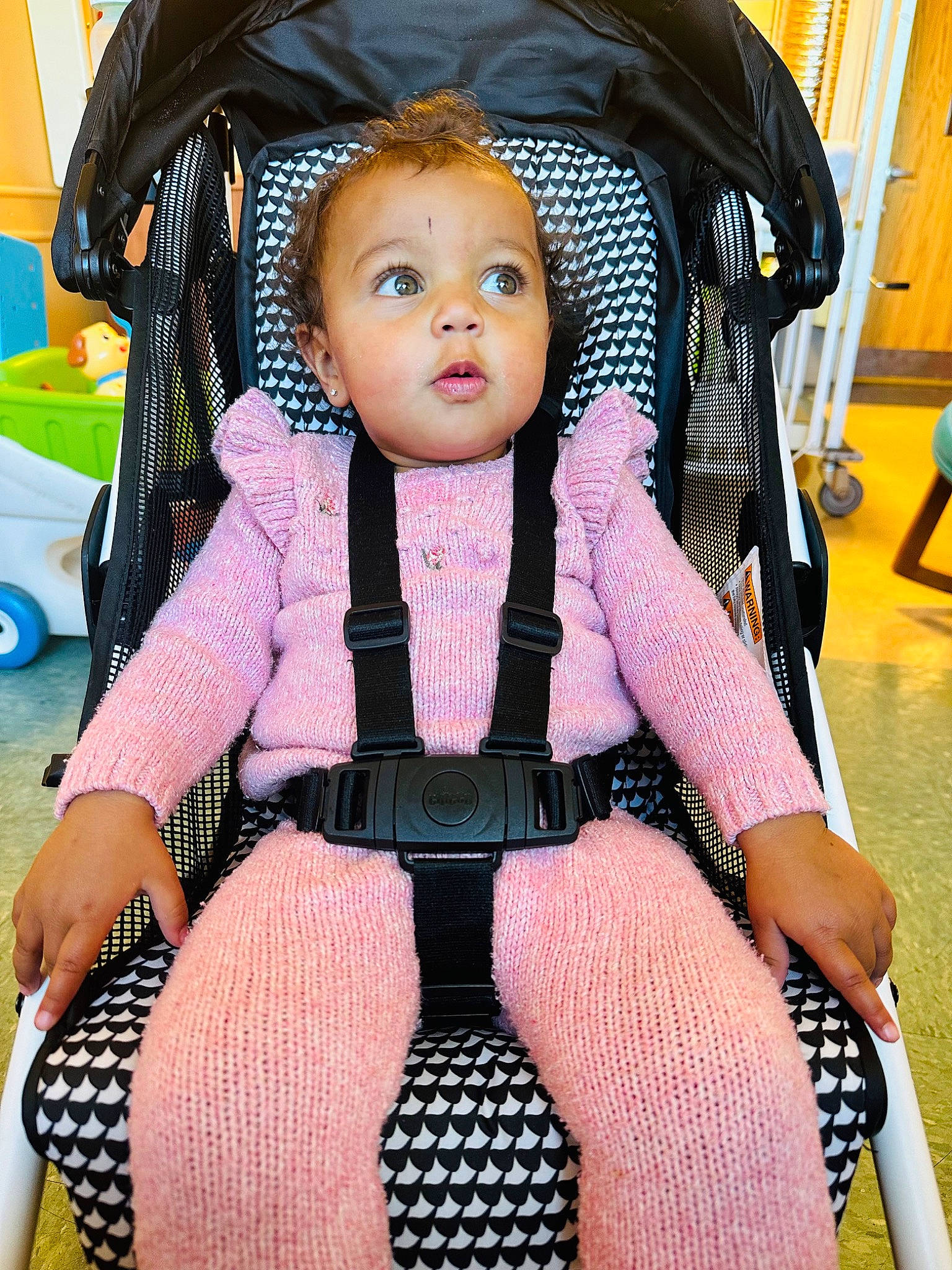 Tiara Royalty is registered to the contest to win money with this photo: baby, baby_carriage, baby_products, baby_toddler_clothing, black, blue, chair, cheek, doll, eye, fun, human_leg, lap, person, pink, sitting, skin, thigh, toddler, toy