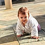 Romane participe au concours pour gagner de l'argent avec cette photo : baby, toddler, crawling, sweater, cable_knit, patio, stone_tiles, outdoor, sunlight, shadow, hands, face, smile, blue_eyes, hair, portrait, cute, closeup, floor, infant