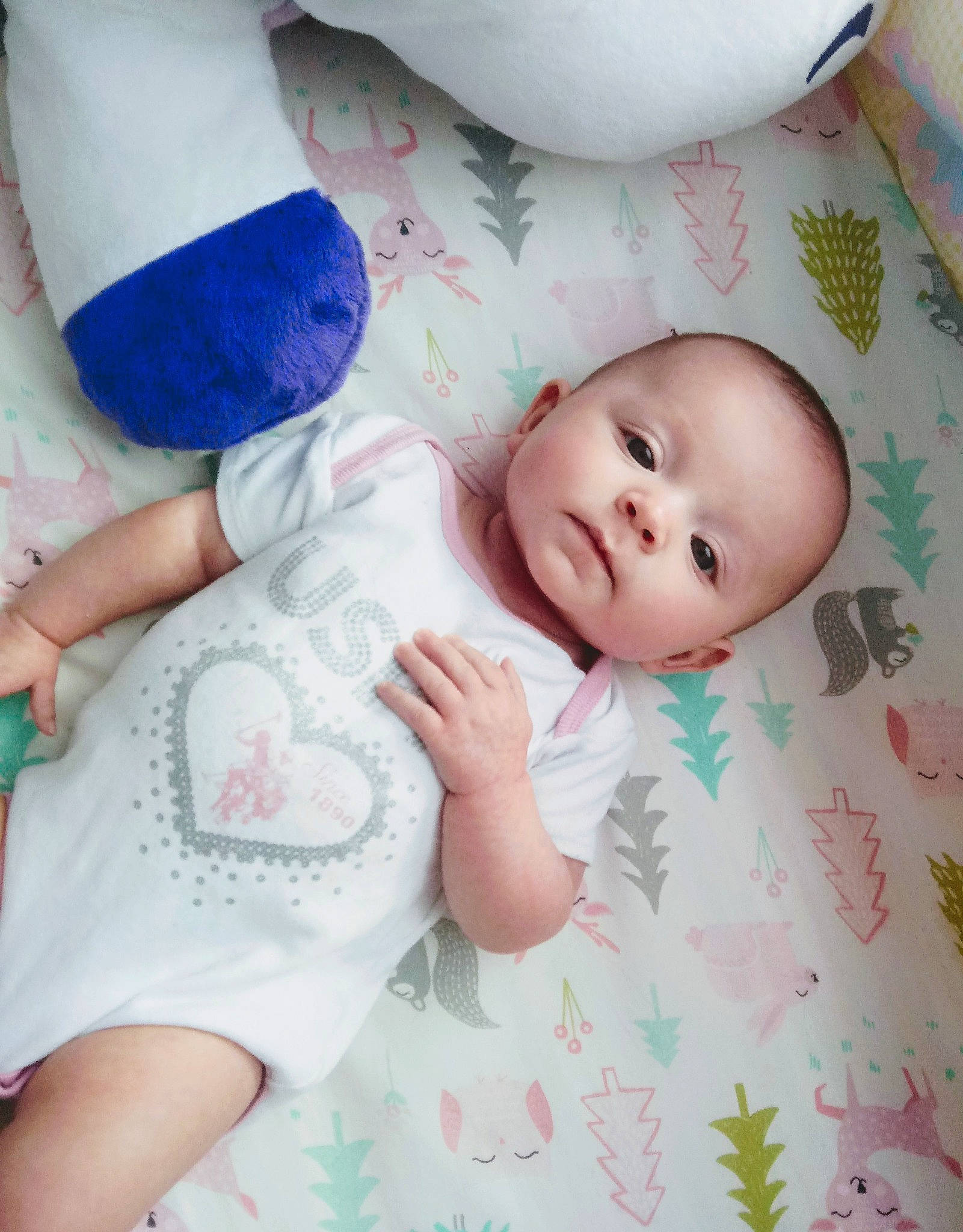 Amanda is registered to the contest to win money with this photo: baby, baby_products, baby_toddler_clothing, bedtime, cheek, child, comfort, finger, foot, gesture, happy, linens, nail, pattern, person, pink, room, skin, sleeve, textile