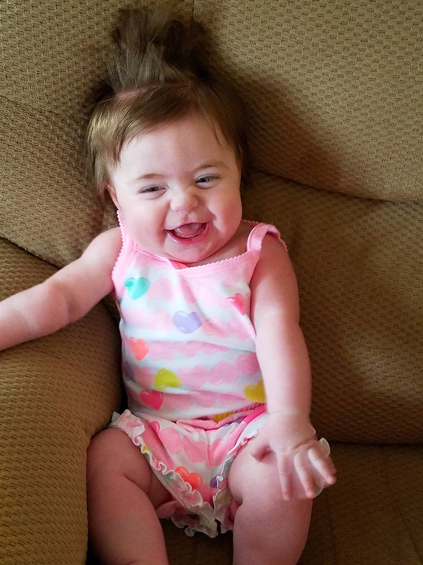 Ainsley is registered to the contest to win money with this photo: arm, cheek, child, day, eye, finger, fun, girl, hand, happiness, human_hair_color, infant, iris, joy, leg, mouth, person, pink, sitting, skin