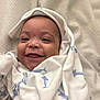 baby, smiling, blanket, white, blue, shark_pattern, hood, cute, infant, face, portrait, happy, cozy, soft, child, wrapped, lying_down, fabric, texture, closeup