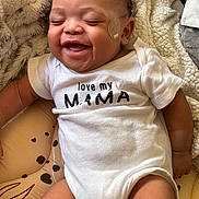 Aspen And Denver is registered to the contest to win money with this photo: baby, infant, smiling, onesie, bandage, cheek, cushion, blanket, fabric, happy, child, person, skin, clothing, closeup, indoors, cute, laughing, newborn, resting