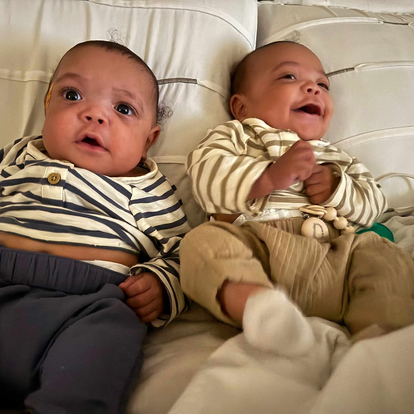 Aspen And Denver joined the competition — help win amazing prizes! baby, child, couch, cozy, cute, furniture, hands, happy, indoor, infant, laugh, pajamas, person, portrait, sitting, smile, striped_clothing, two_people, white_background, young_child