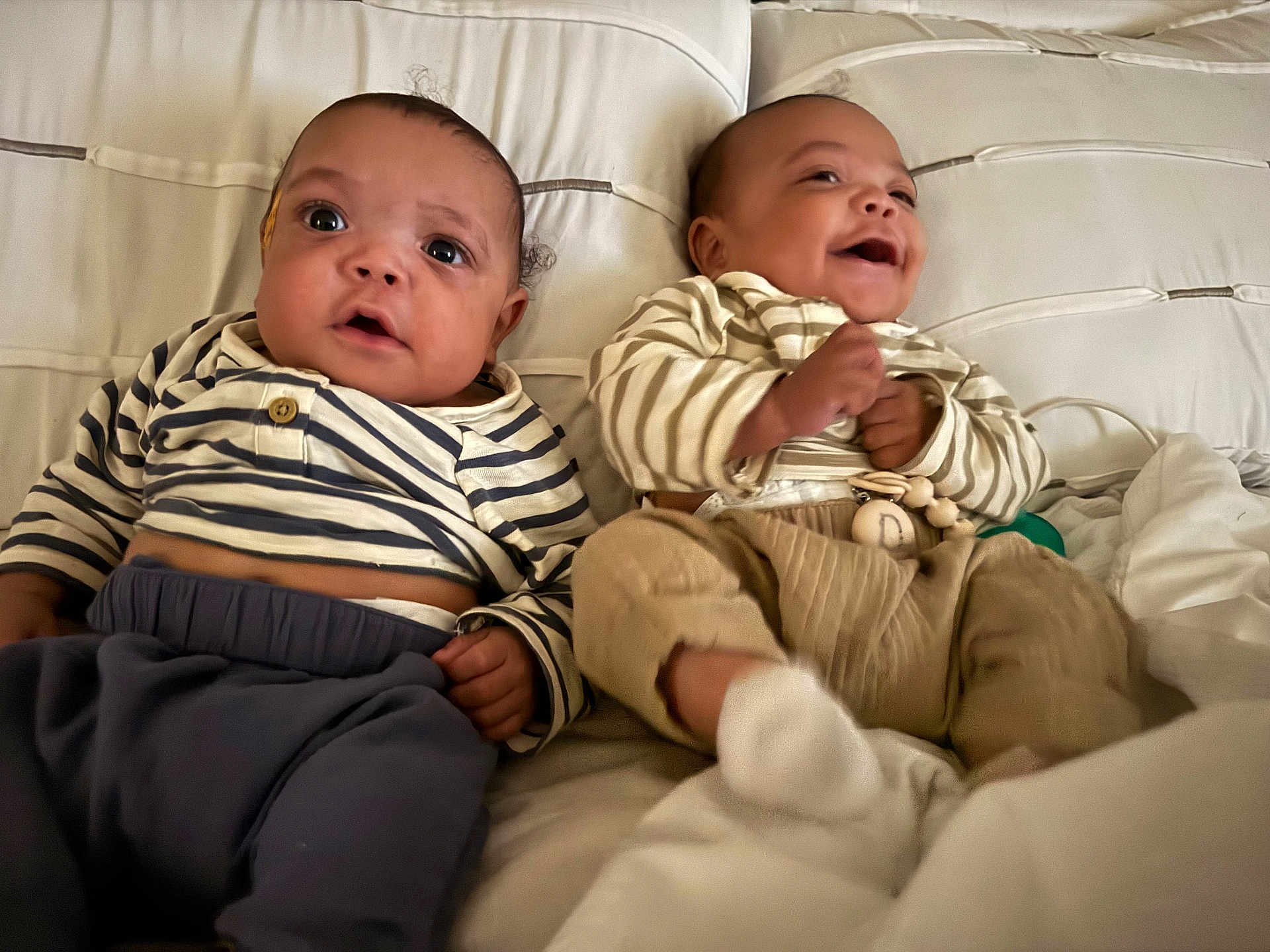 Aspen And Denver joined the competition — help win amazing prizes! baby, infant, child, couch, striped_clothing, smile, laugh, happy, indoor, cute, person, sitting, white_background, pajamas, cozy, furniture, two_people, portrait, young_child, hands