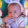 baby, bunny_ears, easter_eggs, bubbles, blue_overalls, striped_clothing, infant, portrait, cute, child, celebration, holiday, spring, colorful, festive, headwear, hand, soft_toy, smiling, fun