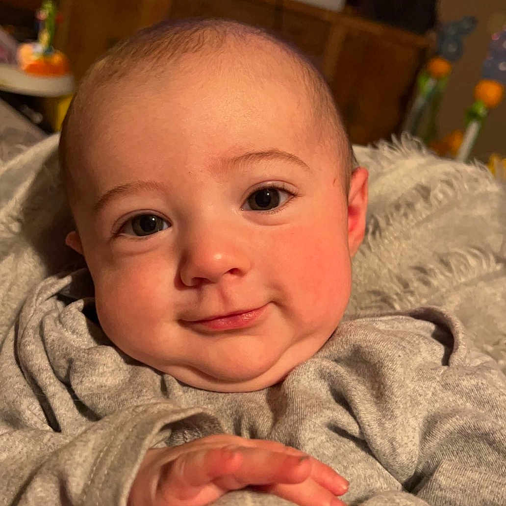 Keaton is registered to the contest to win money with this photo: baby, blanket, bodypart, computerhardware, cutlery, electronics, face, finger, furniture, hand, happy, hardware, head, newborn, person, photography, portrait, quilt, smile, spoon