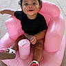 Naeliya joined the competition — help win amazing prizes! baby, black_shirt, bow, child, concrete_floor, curly_hair, cute, footwear, happy, inflatable_chair, outdoor, person, pink, playful, sandals, sitting, small, smiling, summer, toddler