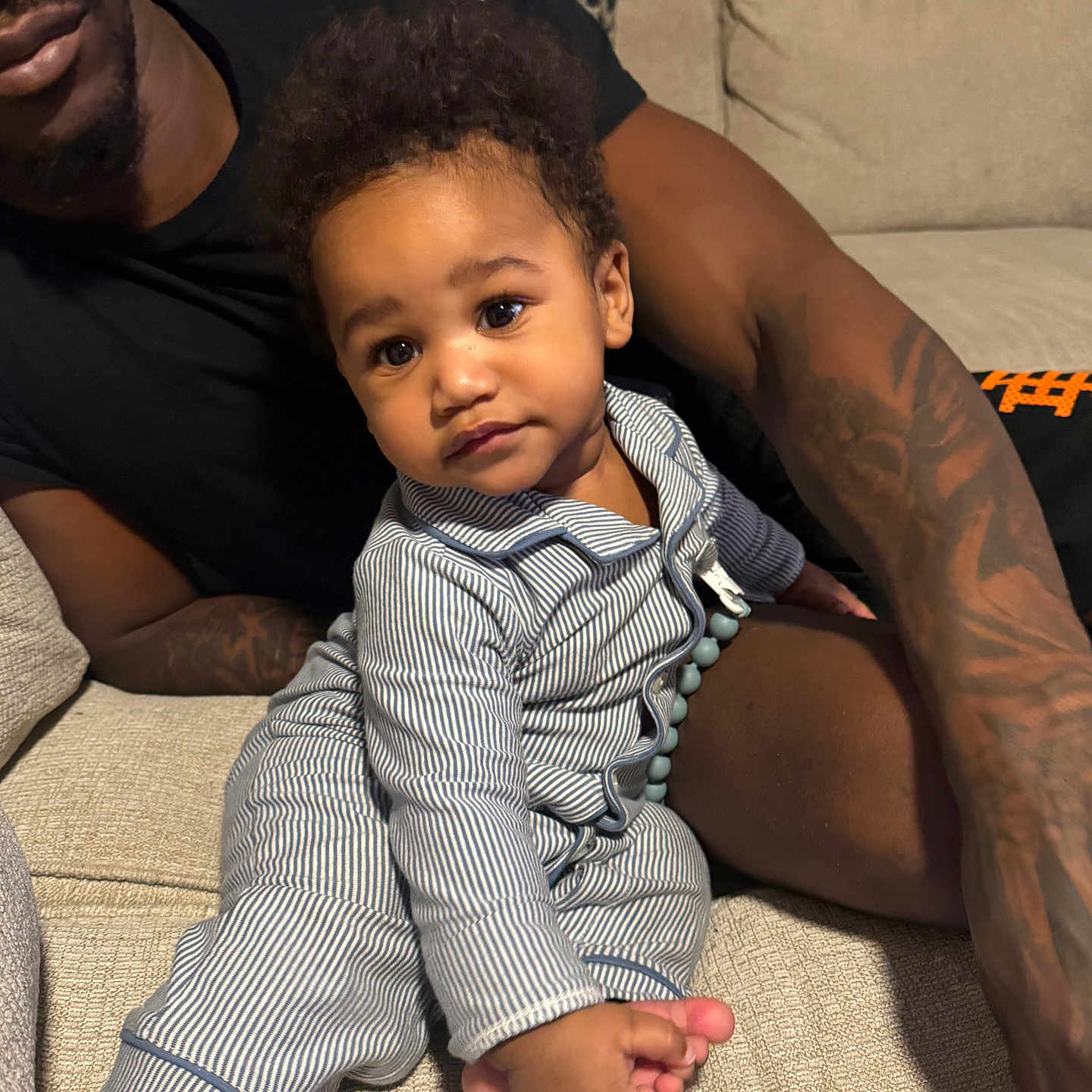 Chozen joined the competition — help win amazing prizes! ankle, baby, bodypart, couch, cushion, face, finger, furniture, hand, happy, head, homedecor, indoors, person, photography, portrait, sitting, skin, smile, tattoo