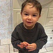Livio participe au concours pour gagner de l'argent avec cette photo : bathroom, boy, cabinet, child, clothing, cute, floor, hair_tie, indoor, jeans, mickey_mouse, pony_tail, sink, smiling, soap_dispenser, standing, sweater, tiles, toddler, towel
