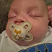 Denni joined the competition — help win amazing prizes! baby, pacifier, sleeping, close_up, infant, face, cute, child, resting, soft, toddler, clothing, white_shirt, blue_print, peaceful, nose, mouth, head, skin, eyes_closed