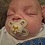 baby, pacifier, sleeping, close_up, infant, face, cute, child, resting, soft, toddler, clothing, white_shirt, blue_print, peaceful, nose, mouth, head, skin, eyes_closed
