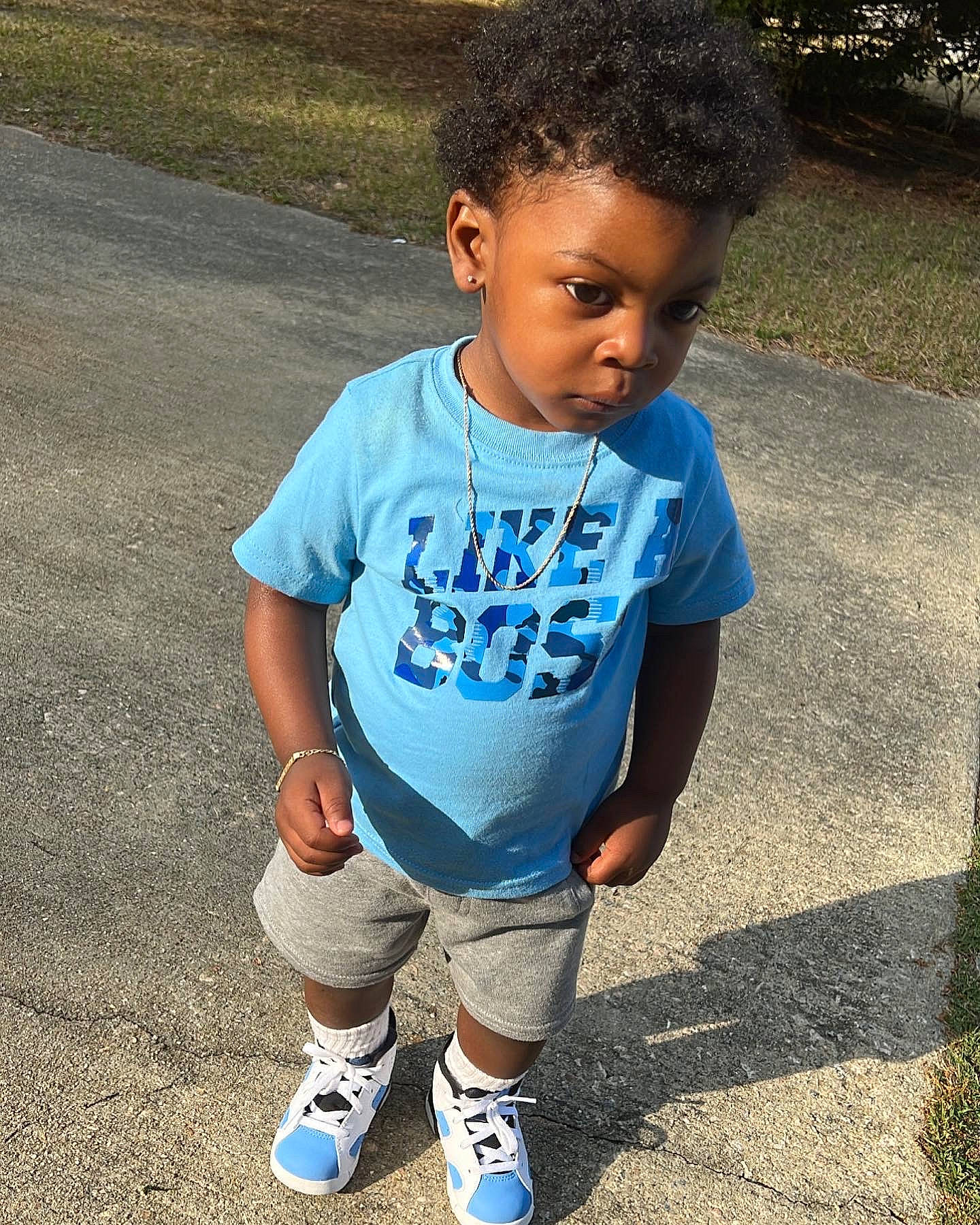 Khamari is registered to the contest to win money with this photo: baby_toddler_clothing, cool, electric_blue, eye, grass, hair, happy, head, leg, leisure, person, shoe, shorts, sleeve, sneakers, sock, sportswear, street_fashion, t_shirt, thigh