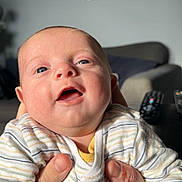 Arthur-James joined the competition — help win amazing prizes! baby, bodypart, clothing, couch, cushion, face, finger, furniture, hand, happy, head, homedecor, indoors, laughing, newborn, person, photography, portrait, shirt, smile