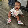toddler, child, sitting, floor, wooden_floor, sneakers, pink_shoes, white_tshirt, nike_logo, happy, smiling, indoors, playroom, toys, storage_bin, shorts, baby, cute, person, casual_clothing
