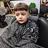 bangs, barber, barber_chair, boy, child, expression_unimpressed, floor_tiles, furniture, haircut, haircut_cape, indoor, mirror, plant, portrait, poster, salon, seat, short_hair, styling_tool_pattern, waiting