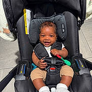 Ryaire joined the competition — help win amazing prizes! baby, car_seat, smiling, child, toy, infant, clothing, white_socks, floor_tile, black_fabric, safety_harness, head_support, cute, indoor, happy, person, seat, baby_toy, gold_chain, skin