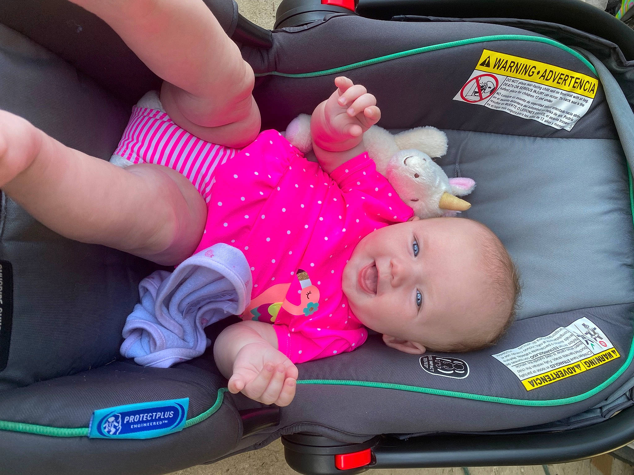 Braxtyn is registered to the contest to win money with this photo: arm, auto_part, baby, baby_carriage, baby_products, baby_safety, baby_toddler_clothing, car_seat, cheek, child, comfort, fun, green, hand, lap, person, pink, product, thigh, toddler