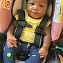 Jenesis joined the competition — help win amazing prizes! baby, child, car_seat, safety_harness, yellow_shirt, smiley_face_pants, bows, hair_accessories, footwear, plastic_shoes, indoor, infant, cute, person, seat, fabric, close_up, portrait, skin, expression