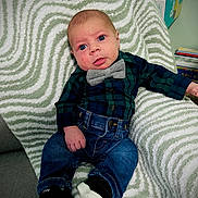 Hansen is registered to the contest to win money with this photo: accessories, baby, bodypart, clothing, couch, cushion, face, footwear, formalwear, furniture, head, homedecor, jeans, pants, person, photography, portrait, shoe, sitting, tie
