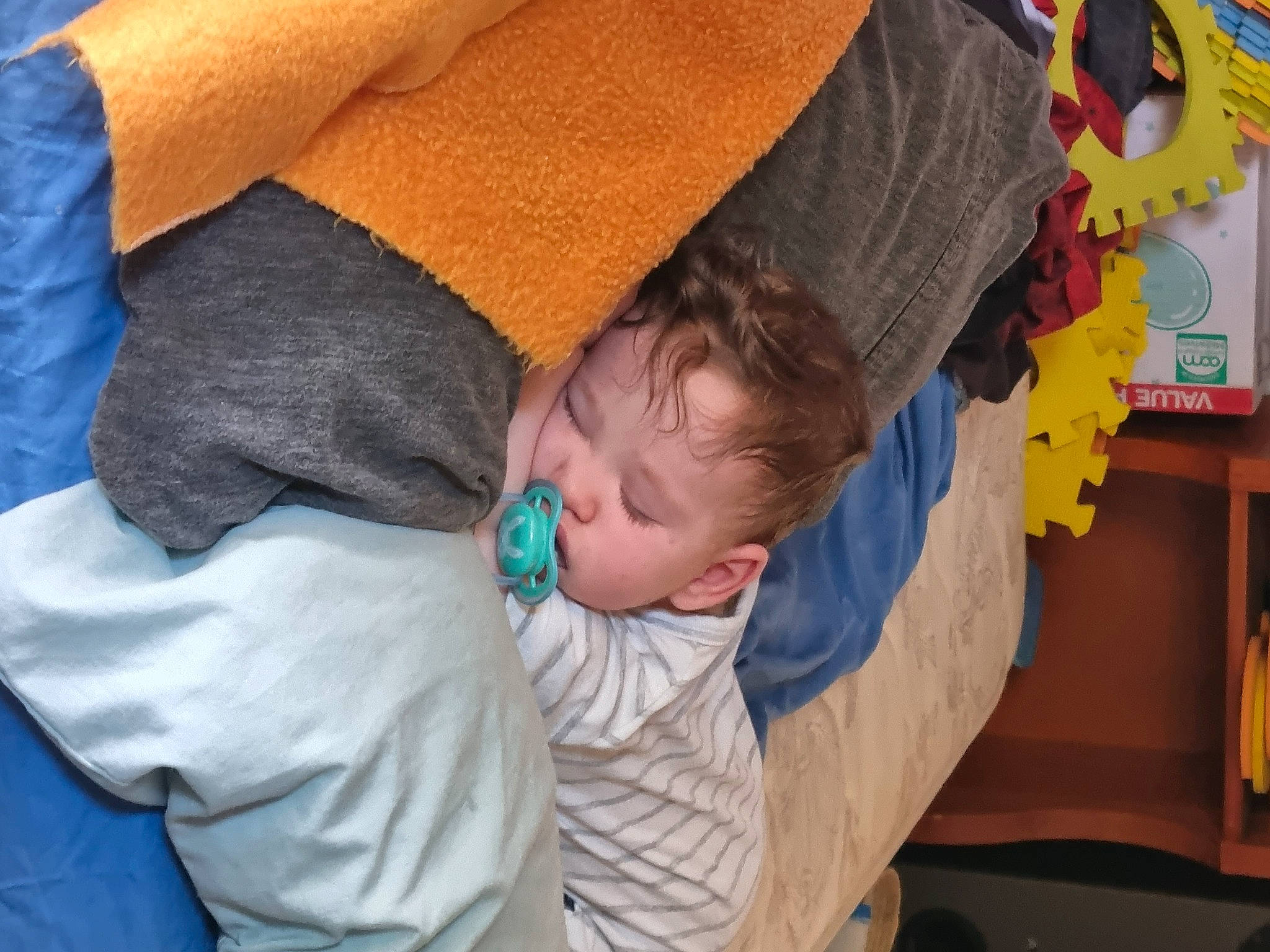 Brock is registered to the contest to win money with this photo: baby, baby_products, bedtime, bookcase, child, comfort, elbow, fun, happy, human_body, lap, leisure, nap, person, room, shelf, sitting, sleep, toddler, tree