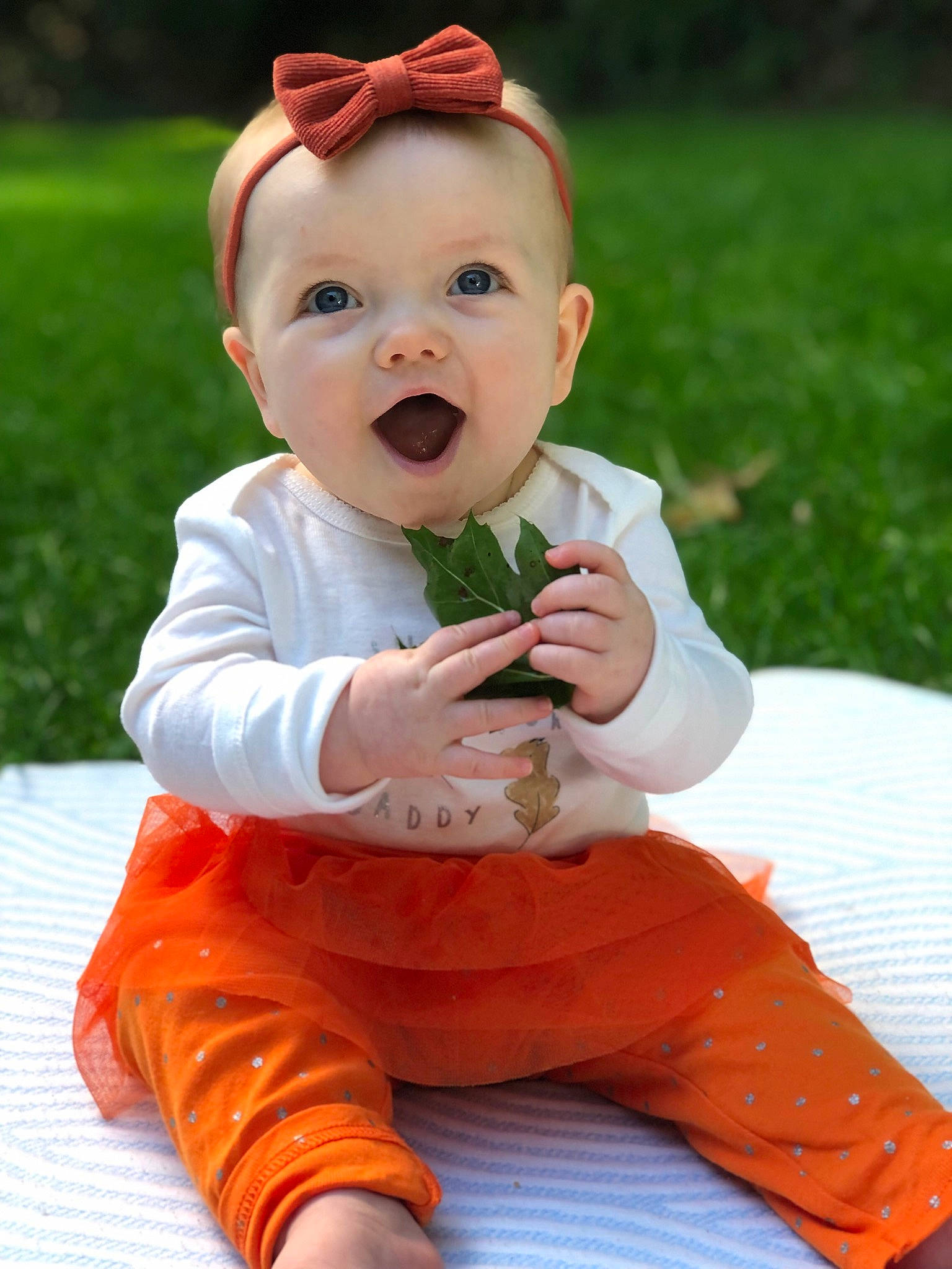 Lucia joined the competition — help win amazing prizes! baby, baby_toddler_clothing, dress, face, finger, grass, hand, happy, hat, head, human_body, knee, leg, leisure, person, pink, skin, sleeve, smile, standing