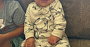 Cason joined the competition — help win amazing prizes! baby, child, smiling, onesie, whale_print, couch, indoor, happy, infant, cozy, sitting, clothing, person, furniture, blanket, cute, portrait, family, casual, home