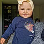 baby, child, smiling, headband, bow, sweater, indoor, person, portrait, face, hand, colorful, clothing, cute, happy, holding, adult, furniture, room, casual