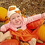 baby, child, pumpkin, orange, hat, striped_clothing, tutu, fall, autumn, outdoor, smile, cute, festive, harvest, nature, person, seasonal, playful, socks, happy