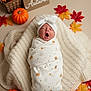 Astrid joined the competition — help win amazing prizes! autumn, baby, basket, blanket, cozy, cute, decor, fall_leaves, headband, indoor, newborn, orange, portrait, pumpkin, red, seasonal, soft, swaddle, yawning, yellow