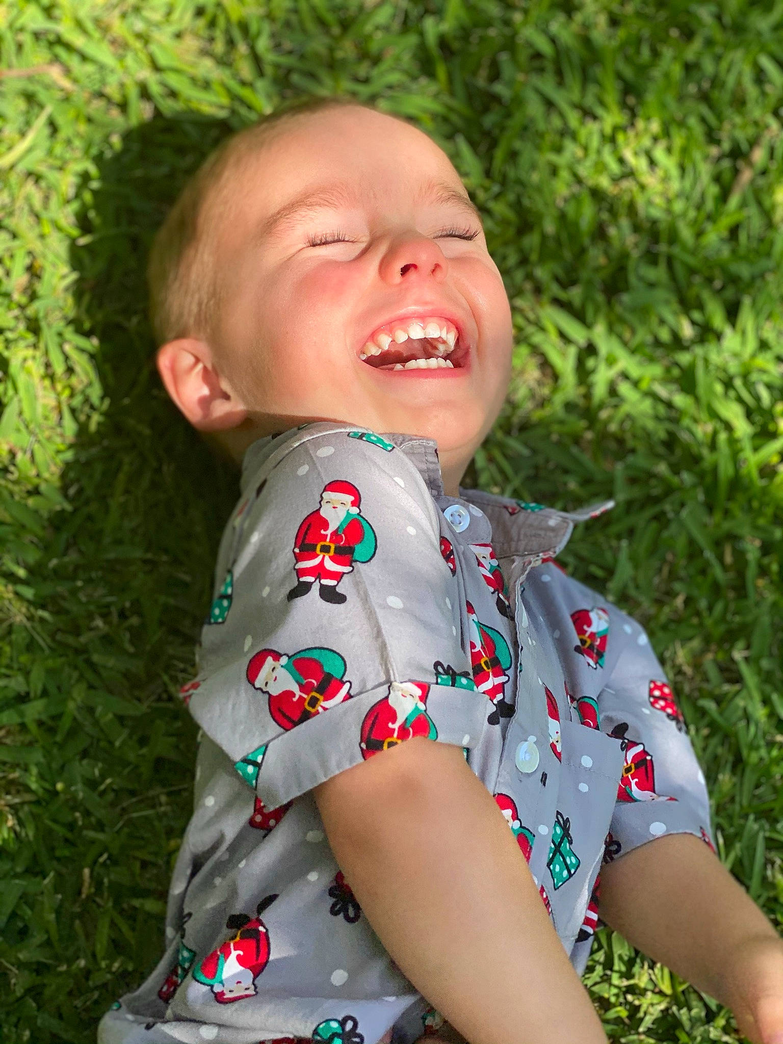 Kobi is registered to the contest to win money with this photo: baby_toddler_clothing, ear, facial_expression, grass_family, happy, humour, laugh, lip, pattern, people_in_nature, person, skin, summer, tongue, tooth
