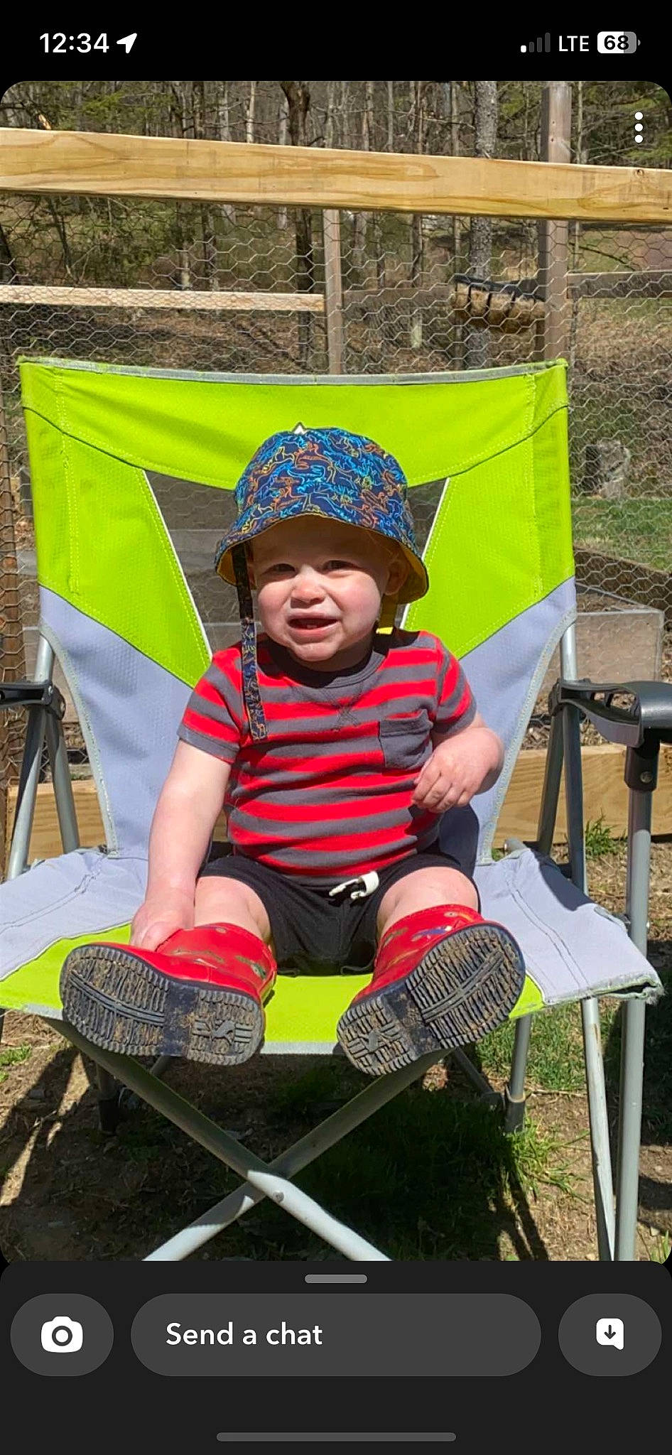 Colson is registered to the contest to win money with this photo: baby, baby_products, camping, chair, child, fashion_accessory, fun, grass, headgear, headwear, joy, landscape, leisure, outdoor_furniture, people_in_nature, person, personal_protective_equipment, recreation, shorts, sitting