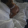 dog, puppy, brown_dog, collar, blanket, white_blanket, bed, resting, sleeping, cozy, indoor, comfort, soft_light, texture, animal, pet, relaxing, snuggling, fur, side_view