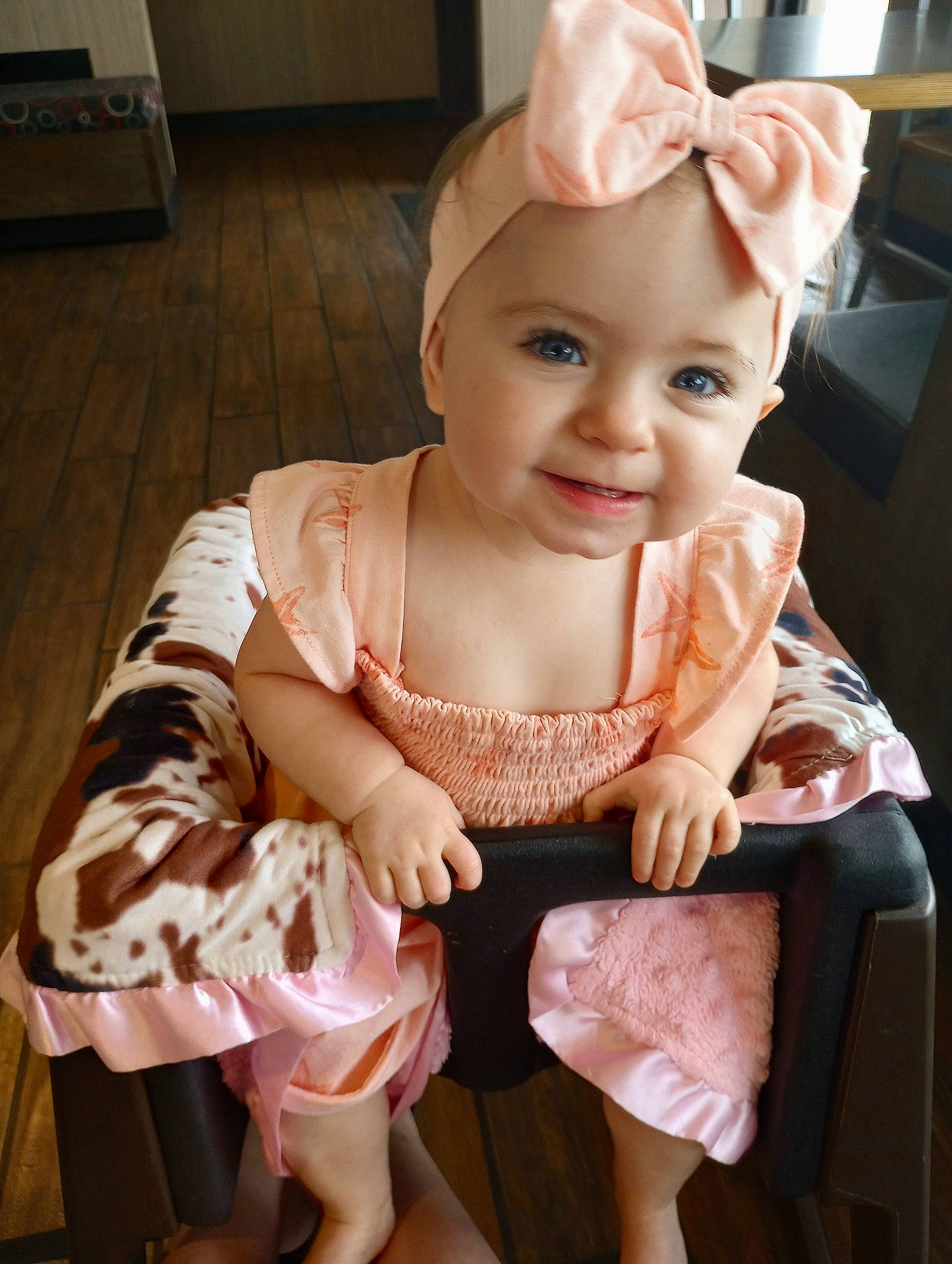 Isabella is registered to the contest to win money with this photo: baby, baby_toddler_clothing, cheek, child, day_dress, embellishment, fashion_accessory, flooring, foot, happy, headwear, human_body, human_leg, joy, pattern, person, pink, sitting, skin, sleeve