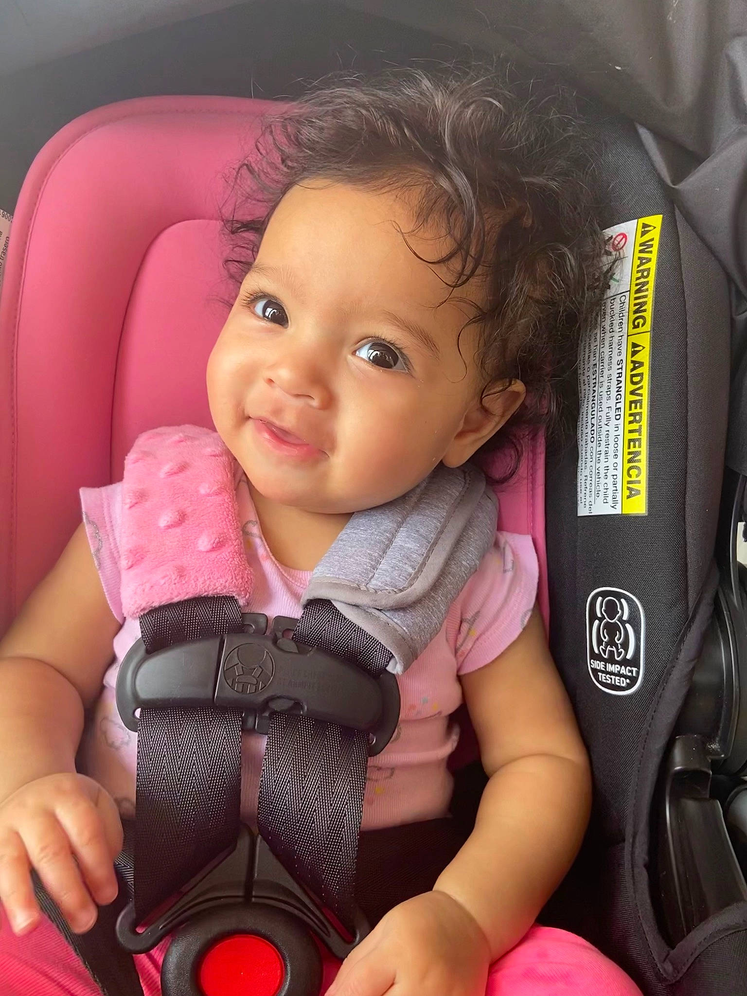 Amiyah is registered to the contest to win money with this photo: baby, baby_carriage, baby_toddler_clothing, car_seat, cheek, comfort, facial_expression, finger, hairstyle, hand, material_property, mouth, people, person, pink, product, seat_belt, skin, smile, thumb