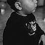child, toddler, portrait, black_and_white, profile, face, eyes, ear, eyelashes, cheeks, hair, sitting, indoor, clothing, shirt, pajamas, mickey_mouse, curious, closeup, nostalgic
