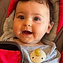 baby, infant, car_seat, pacifier, gray_shirt, red, smiling, happy, child, cute, portrait, hand, face, indoors, seatbelt, curly_hair, skin, cheeks, young, person