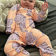 Piper joined the competition — help win amazing prizes! baby, bed, child, cozy, cute, face, hand, happy, indoors, infant, onesie, patterned_clothing, peach, person, pillow, portrait, purple, resting, smile, soft_fabric